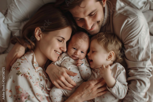 Cinematic photo of happy family with two children, mother and father lying on the bed in their bedroom at home