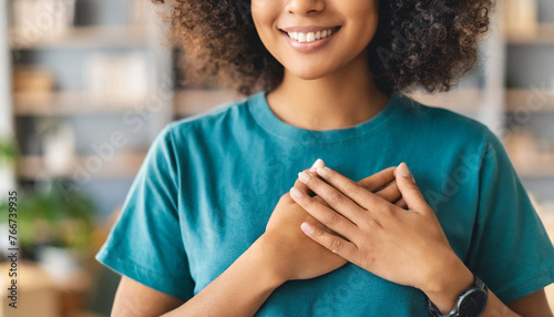  woman with folded hands on heart, expressing gratitude