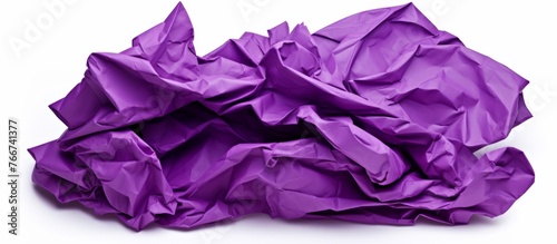 A heap of crumpled violet paper on a white backdrop resembling petals of a flowering plant. The contrast of magenta and electric blue creates a creative arts pattern reminiscent of art