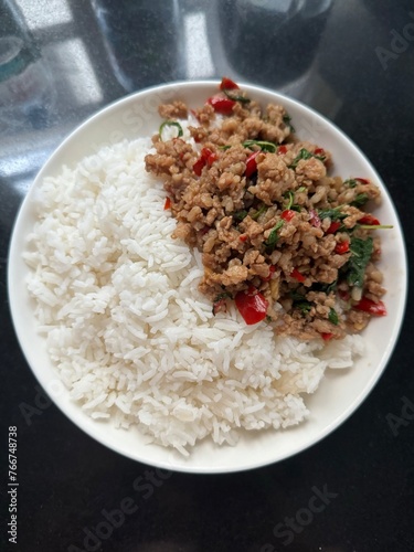 Top view of Thai holy basil rice with minced pork for Thai street food, Asian food, cafe, restaurant, menu, recipe, cook book, print, food delivery, social media post, ads, lunch, dinner, cuisine