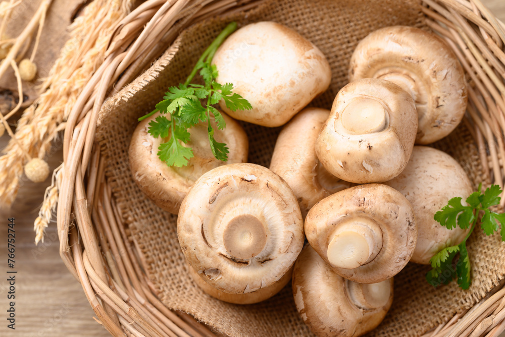 Fresh Champignon mushroom in natural basket, Top view Fresh Champignon mushroom in natural basket, Top view