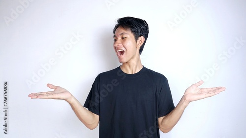 young asian man excited gesturing showing both open palms photo