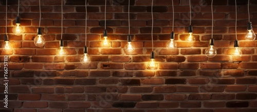 A series of amber light bulbs adorn a brick wall, creating a warm glow. The symmetry of the pattern contrasts with the rugged brickwork of the building material