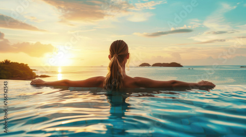 A beautiful young woman in a pool with a stunning mesmerizing ocean view