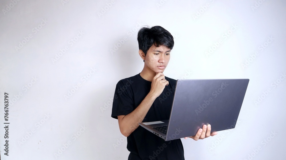 young asian man excited with gesture holding laptop thinking surprised confused young asian man excited with gesture holding laptop thinking surprised confused