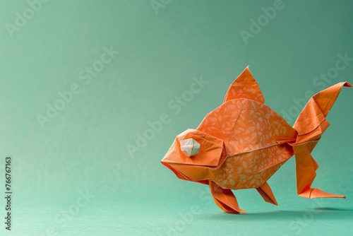 origami Goldfish on pastel green background