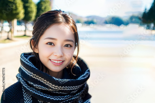 冬のデートでマフラーを巻いて笑顔でカメラ目線の日本人女性(モデル美女) photo