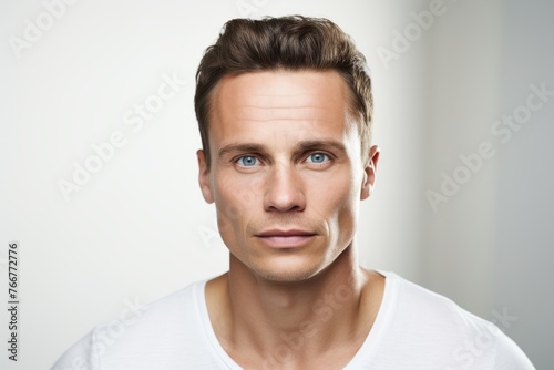 Handsome young man in white t-shirt. Studio shot.