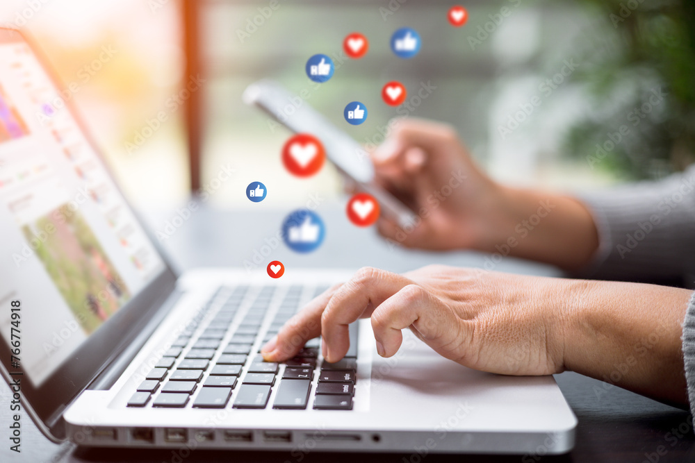 © JD8 - Social media concept. Young female using smart phone, Business woman working on laptop computer in street cafe. My job in my hand. Businesswoman sitting in cafe. Focus of hand.