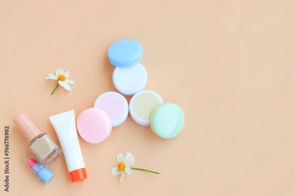 Cosmetic bottle containers with White flower, isolated on beige background, Beauty products Cosmetic bottle containers with White flower, isolated on beige background, Beauty products