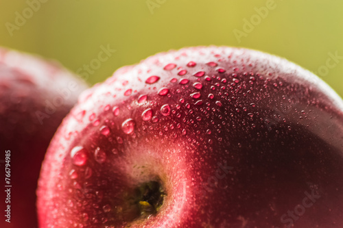 Close up of fresh red apple with water drops on the surface.