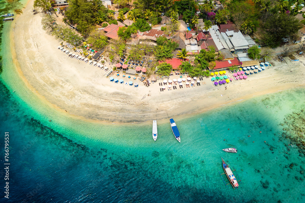 Aerial view of a tropical beach resort next to a coral reef on a small island (Gili Air, Indonesia)