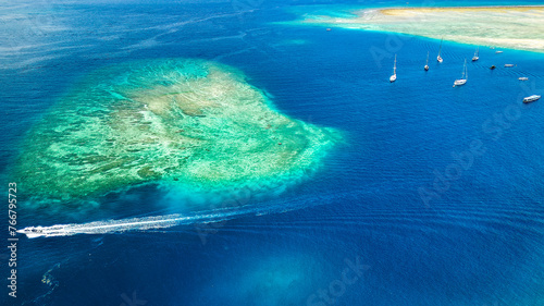 Aerial view of a fringing tropical coral reef around the coastline of a tiny island in Indonesia (Gili Air)