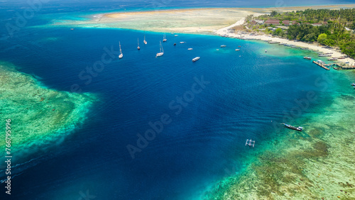 Traditional outrigger boats on the tropical coral reef off Gili Air near Lombok, Indonesia