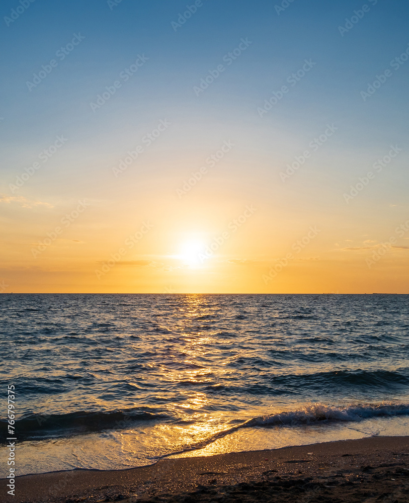 Vertical front viewpoint landscape travel summer sea wind wave cool on holiday calm coastal big sun set sky light orange golden Nature tropical Beautiful evening hour day At Bang san Beach Thailand.