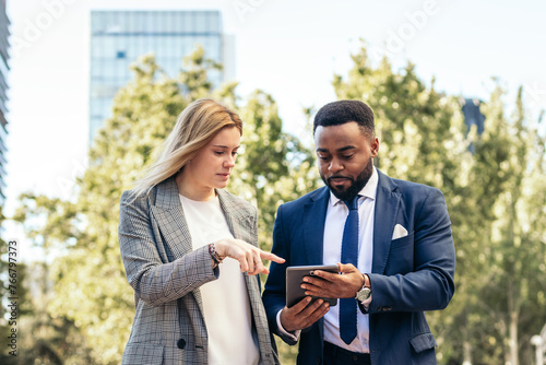 Coworkers talking about business outdoors photo