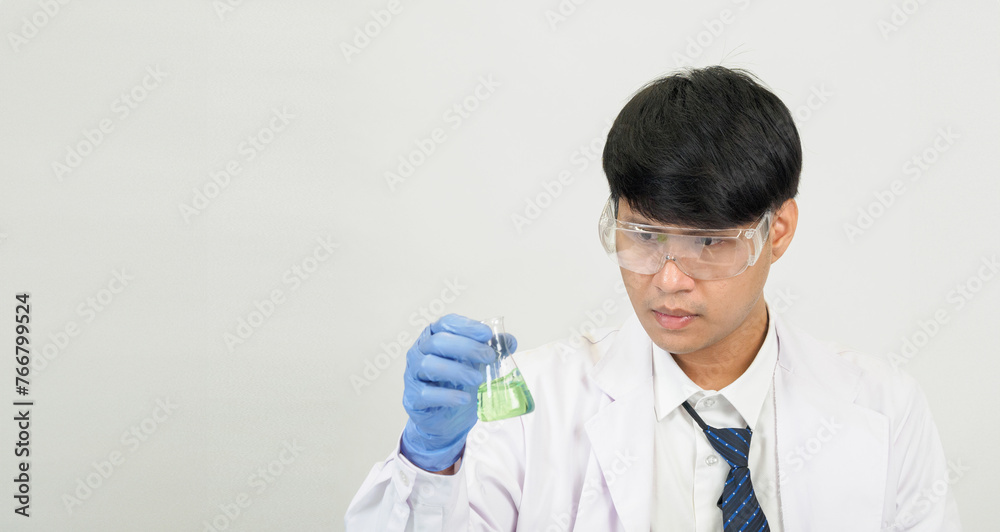 Portrait asian man student scientist or doctor look hand holding reagent mixing laboratory in science research laboratory with test tubes of various size in laboratory chemistry lab white background Portrait asian man student scientist or doctor look hand holding reagent mixing laboratory in science research laboratory with test tubes of various size in laboratory chemistry lab white background