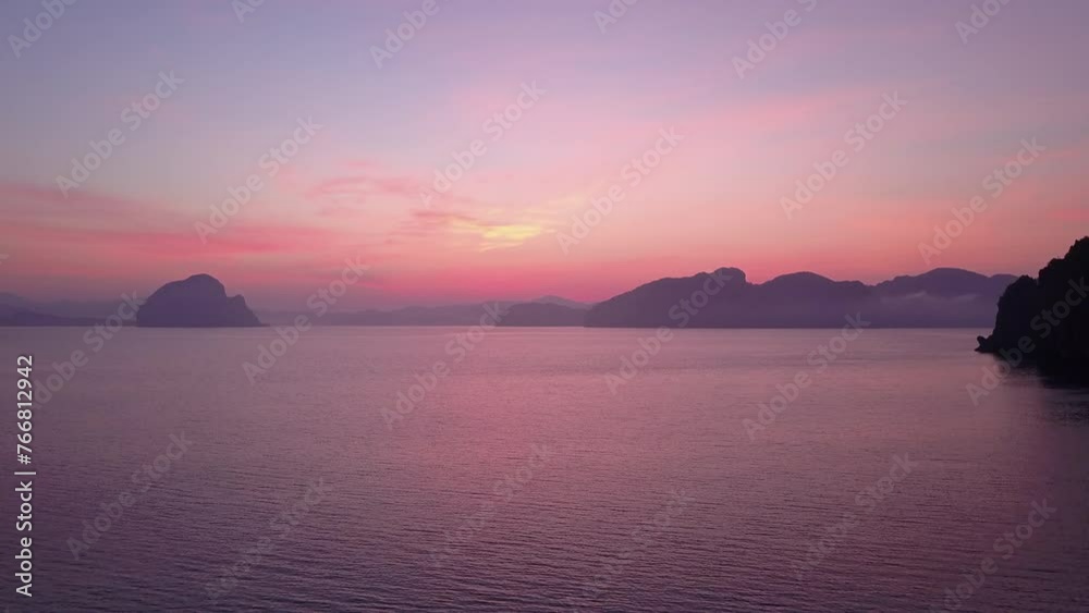 Aerial Forward Shot Of Tranquil Rock Formations In Wavy Sea Against Cloudy Sky At Sunset - Palawan, Philippines Aerial Forward Shot Of Tranquil Rock Formations In Wavy Sea Against Cloudy Sky At Sunset - Palawan, Philippines