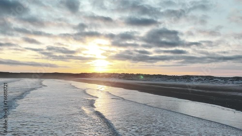 Waves In The Shoreline Of Black Sand Beach In Stokksnes At Sunrise In South East Iceland. - aerial shot photo