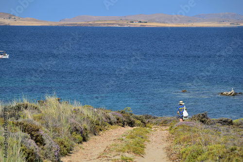 seascape with a woman on a path, at sea coast - Fanaraki area, near Moudros, Lemnos, Aegean Sea, Greece photo