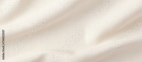 Detailed view of a subtle pattern on a white fabric, showcasing its intricate and delicate design