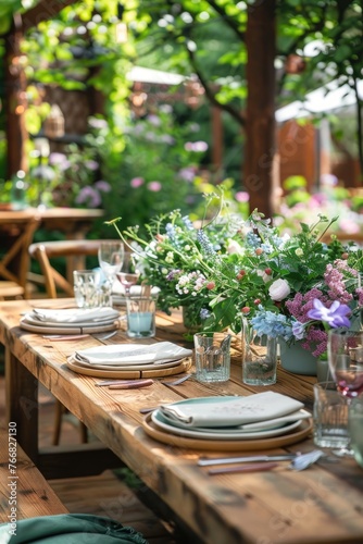 Elegant outdoor garden dinner table setting with flowers and lights.