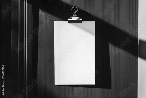 Close up mockup of a blank white door hanger on a black hotel room doorknob