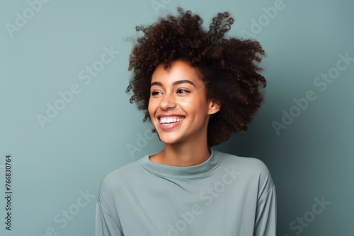Beautiful african american woman with afro hairstyle on blue background