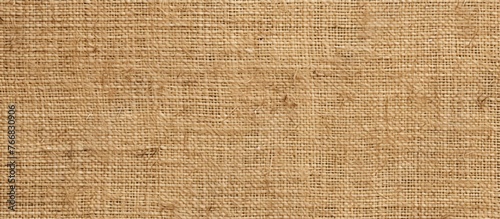 Detailed view showing the intricate pattern and texture of a brown burlap cloth, perfect for backgrounds or design projects