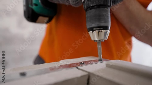 Wallpaper Mural An electric drill is used to make a hole for attaching a steel rod to a reinforced concrete structure. Drilling, strengthening block walls. Home improvement, wall repair using an electric drill. Torontodigital.ca