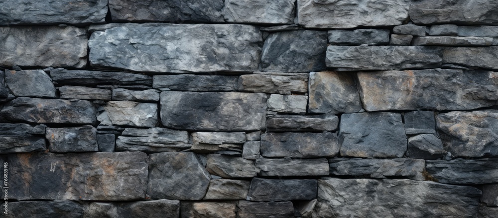 A detailed view of a stone wall with a fire hydrant positioned in front of it A detailed view of a stone wall with a fire hydrant positioned in front of it