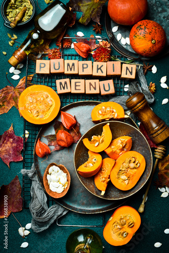 Autumn banner with pumpkins. Orange pumpkins on a stone table, holiday decoration. Pumpkin menu. Top view.