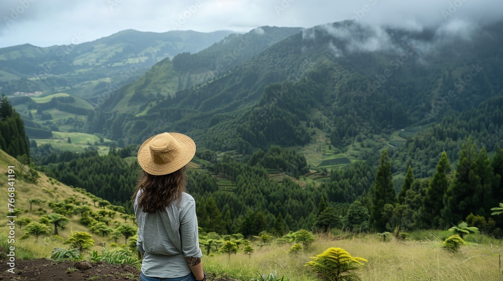 woman looking at epic mountain landscape and forest holding hat wanderlust travel concept with space for text and atmospheric scene woman looking at epic mountain landscape and forest holding hat wanderlust travel concept with space for text and atmospheric scene