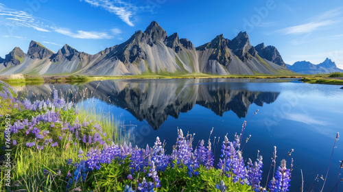 A stunning landscape of Iceland's Stokksnes, featuring the majestic flat-topped mountain and vibrant blue skies. The scene includes an enchanting lake reflecting distant mountains
