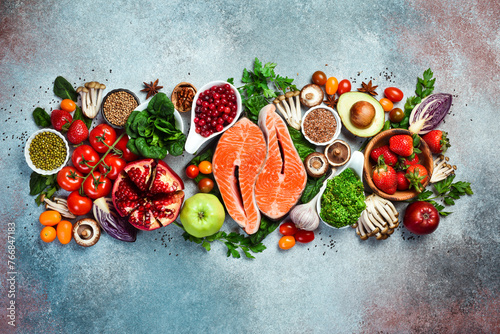 Balanced diet food background. Healthy food clean eating concept. Fish, nuts, fruits and vegetables, superfood.
