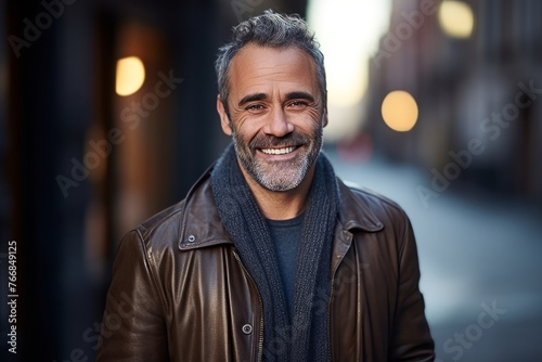 Portrait of a smiling middle-aged man in the city.