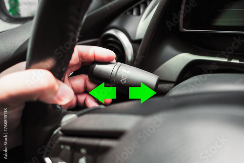 Driver hand using turn signal in a car , Vehicle driving concept