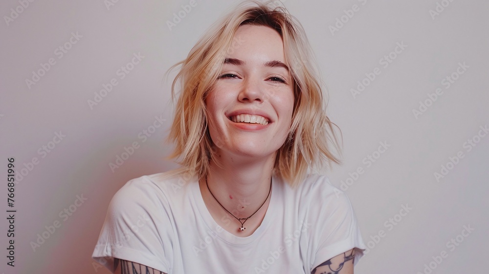 joyful female with blonde hair, casual style, smiling happily, studio portrait of pretty woman, satisfied look, isolated against blank wall joyful female with blonde hair, casual style, smiling happily, studio portrait of pretty woman, satisfied look, isolated against blank wall