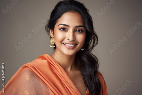 Portrait of a smiling young woman of Indian ethnicity having long flowing hair
