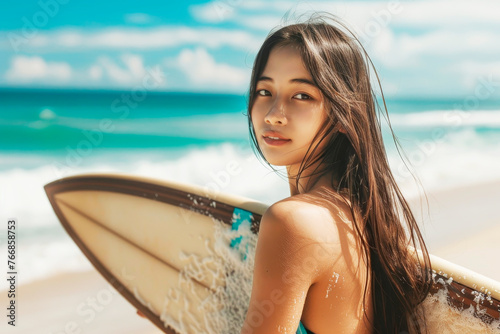Ocean-loving surfer girl holding her surf board, ocean waves in the background, surfing concept © vasanty