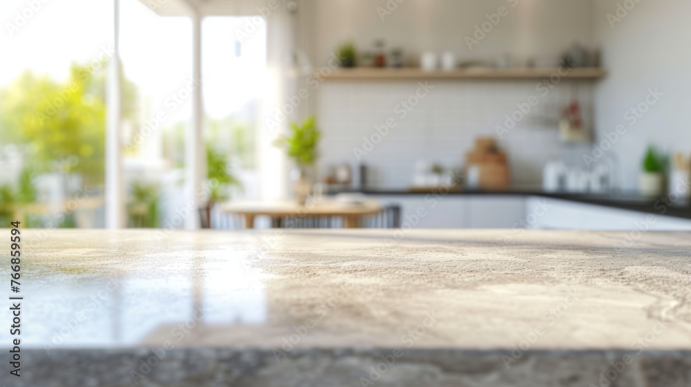 Close-up of a stone countertop bathed in natural sunlight with a softly focused modern kitchen and greenery outside the window in the background Close-up of a stone countertop bathed in natural sunlight with a softly focused modern kitchen and greenery outside the window in the background