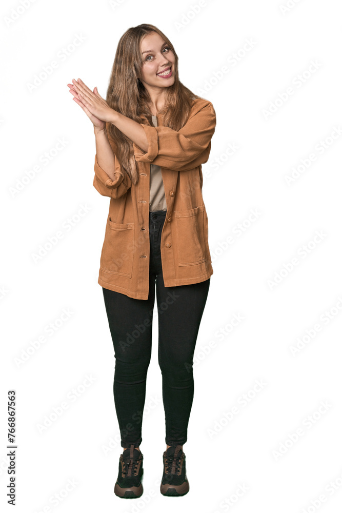 Studio portrait of a blonde Caucasian woman feeling energetic and comfortable, rubbing hands confident. Studio portrait of a blonde Caucasian woman feeling energetic and comfortable, rubbing hands confident.