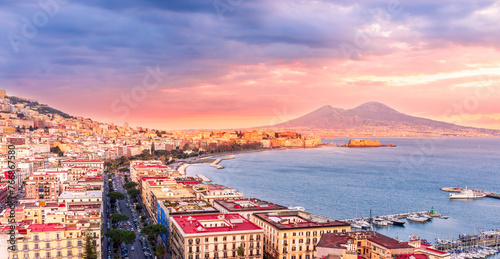 beautiful panorama of Naples city with amazing coast, sea port, streets and buildings and volcano Vesuvius with anazing sky on background photo