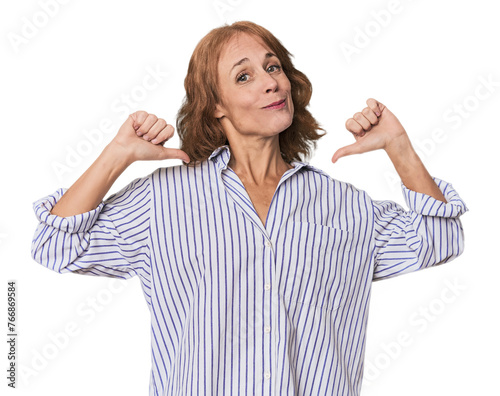 Redhead mid-aged Caucasian woman in studio feels proud and self confident, example to follow.