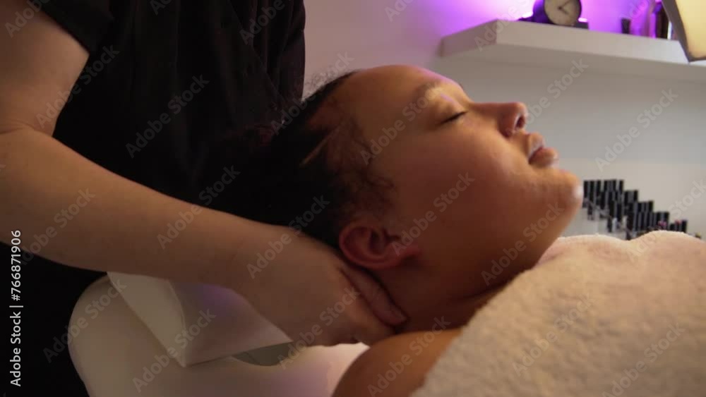 Professional masseuse in salon massaging her beautiful female client her neck. Professional masseuse in salon massaging her beautiful female client her neck.