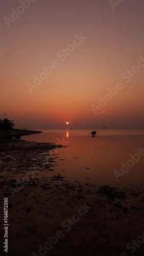 People silhouette are experiencing pure joy as they gather on the beach, delighting in the mesmerizing sunset.