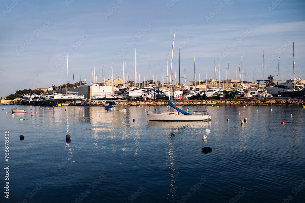 Harbour background. Many sailboats background. Expensive yachts in port. Seashore vacation landscape. Beautiful evening view. Sunrise in sea marina. Water reflection dock. Outdoor ships by the bay.
