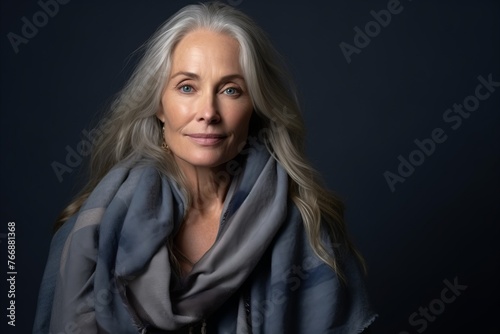 Portrait of a beautiful senior woman with grey hair and blue scarf
