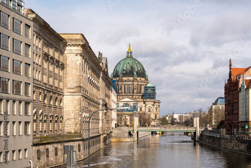 The river flows along the ancient houses of the European city of Berlin. Ancient houses and river in Berlin. © Jakob