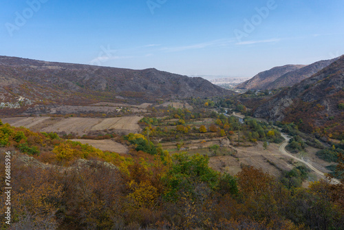 View of the mountains, river, fields and valley from the hill.